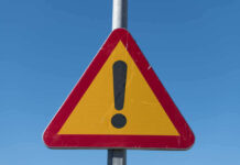 Triangular warning sign with exclamation mark.
