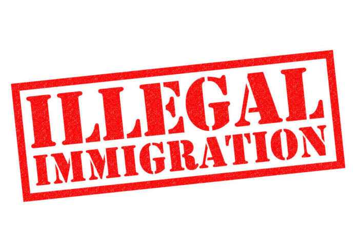 shutterstock_368718257.jpg featured image Red illegal immigration stamp on white background