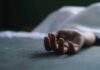 Close-up of a hand under a white sheet.