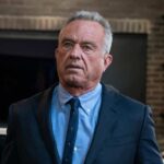 Robert F Kennedy JR in suit indoors.
