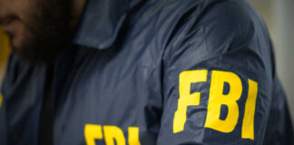 FBI agent in navy blue jacket.