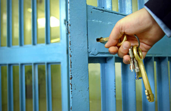 shutterstock_789621847.jpg featured image Hand unlocking blue metal door with keys.