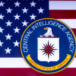 CIA emblem on American flag background.