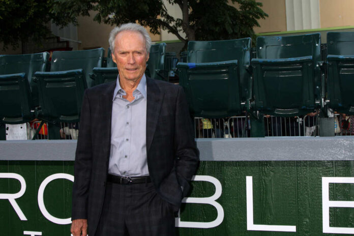 shutterstock_113318677.jpg featured image Man in suit standing in front of green seats
