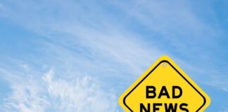 Yellow sign reads bad news in sky