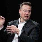 Elon Musk in a suit talking.