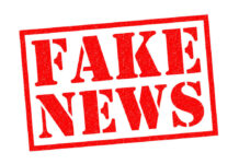 Fake news red stamp with textured appearance