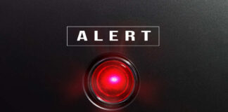 Red alert light on black background