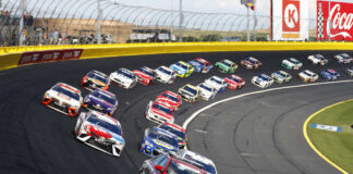 Race cars on a track in formation driving fast
