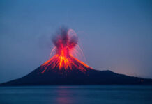 Volcano erupting with bright lava and smoke display