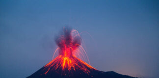 Volcano erupting with bright lava and smoke display