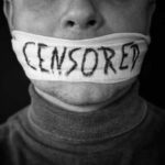 Mouth covered with censored cloth strip
