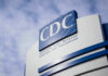 CDC building sign against a cloudy sky