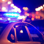 Police car with flashing blue lights at night