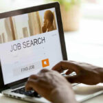 Person searching for jobs on a laptop