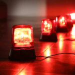 Red emergency lights on dark floor illuminating the area
