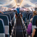 Airplane interior with passengers seated mid-flight
