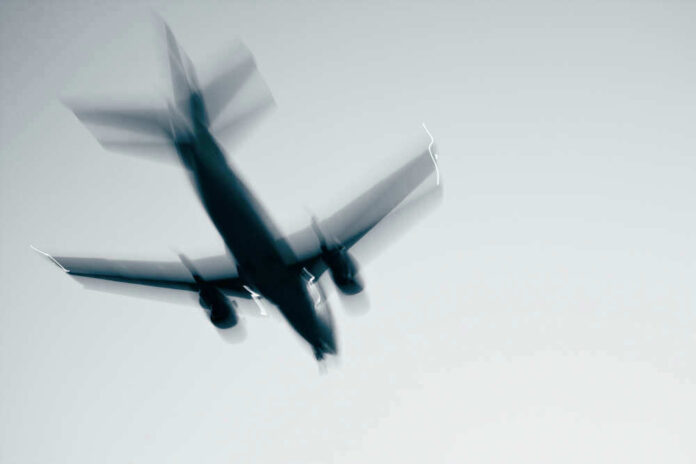 shutterstock_87563047.jpg Airplane in flight with motion blur