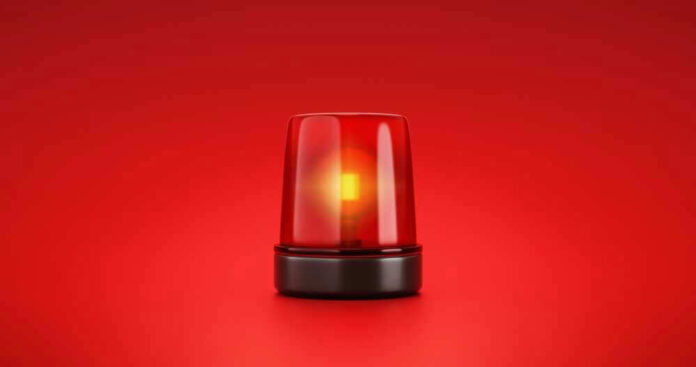 Red emergency light on solid red background