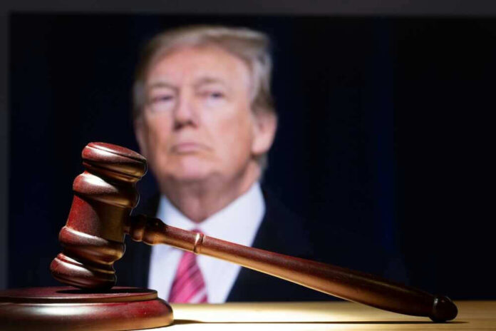 Gavel in foreground with Donald Trump in background