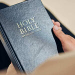 Person holding a Holy Bible