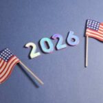 Two small American flags next to the numbers 2026 on a blue background
