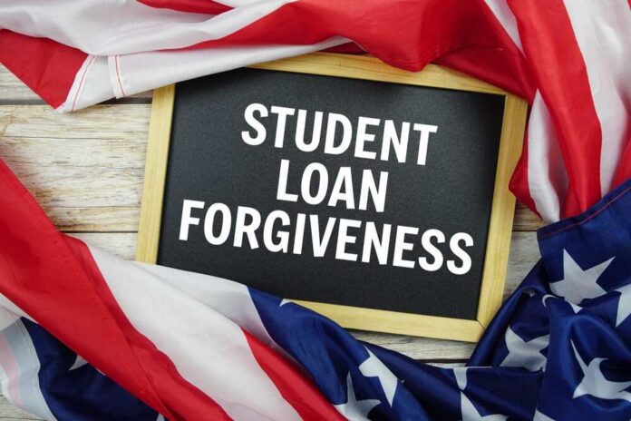 shutterstock_2546804865.jpg Chalkboard with the text STUDENT LOAN FORGIVENESS surrounded by American flags