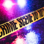 INDICTMENT: He Killed King of the Hill Star Crime scene tape with flashing lights in background.