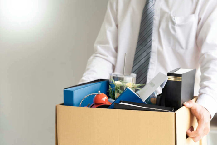 Person holding a box of personal office items.