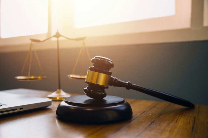 Gavel and scales of justice on desk.