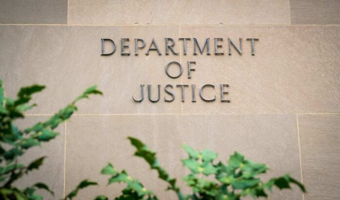 Sign displaying 'Department of Justice' on a stone wall