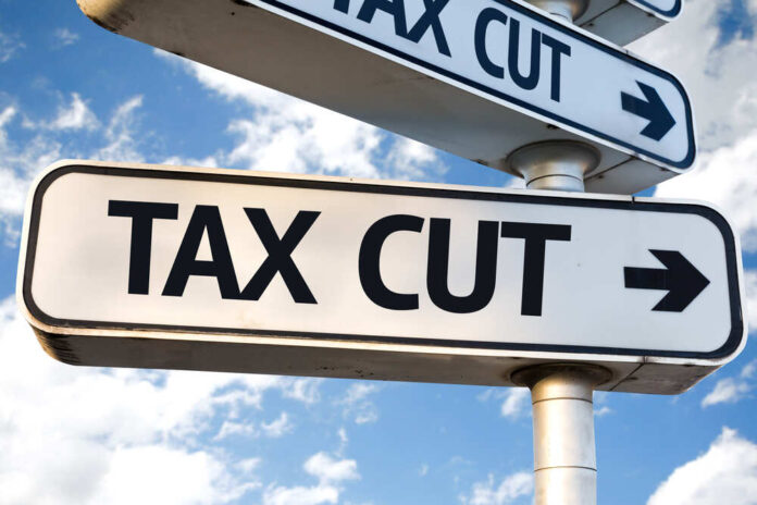 Sign indicating a tax cut with an arrow pointing right