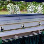 Michael Reagan’s Passing: A Conservative Voice Lost A casket at a graveside surrounded by floral arrangements