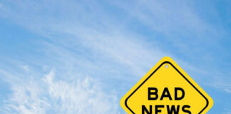 Yellow sign reads bad news in sky