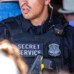 Secret Service officer in uniform with equipment visible.