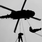 VIDEO: Dramatic Helicopter Rescue Stuns All Silhouette of a helicopter with two individuals being lowered by ropes