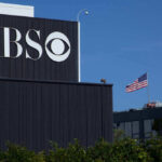 CBS building with American flag in background.