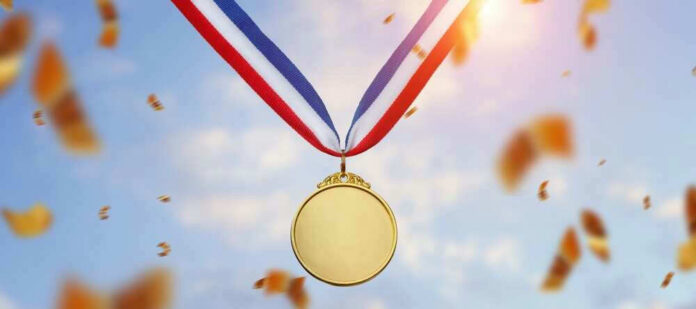 Gold medal with blue, white, red ribbon, sky background.