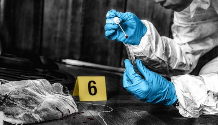 Forensic investigator collecting a blood sample at a crime scene