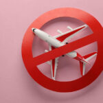 Jet-Fuel Blackout Shuts Airports Airplane inside red prohibition sign on pink background.