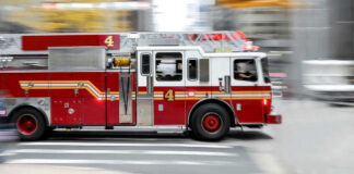 Red fire truck driving on city street
