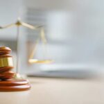 Grand Jury MUTINY Stuns Justice Department A wooden gavel and scales of justice on a desk