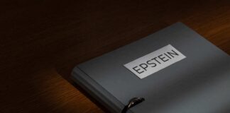 A gray folder labeled 'EPSTEIN' resting on a wooden surface