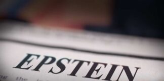 Close-up of a newspaper headline reading 'EPSTEIN'