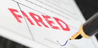 Fountain pen signing document with the word fired