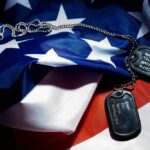 TRUMP CONSIDERING Ground Troops? Military dog tags resting on an American flag