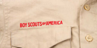 Close-up of a khaki shirt with 'Boy Scouts of America' embroidered on it