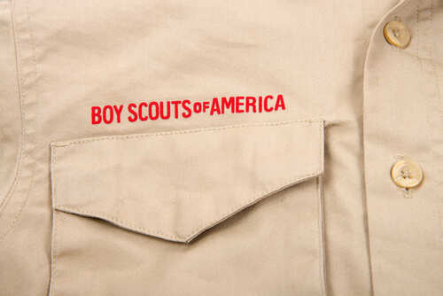 Close-up of a khaki shirt with 'Boy Scouts of America' embroidered on it