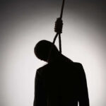 Silhouette of a person hanging with a rope in a dark background