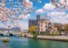 View of the Hiroshima Peace Memorial with cherry blossoms in the foreground